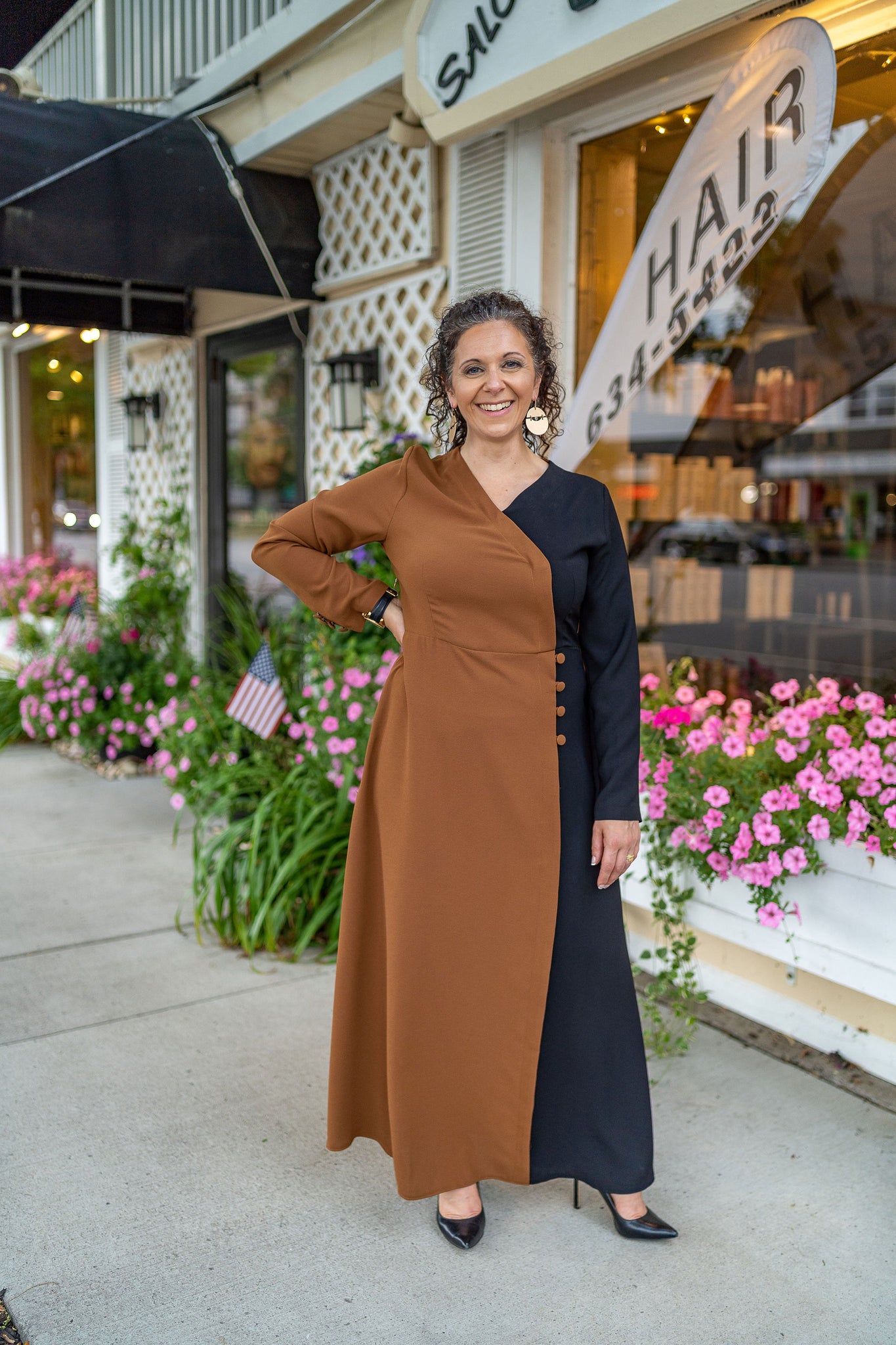 Woman in a black and beige sophisticated long sleeve long dress
