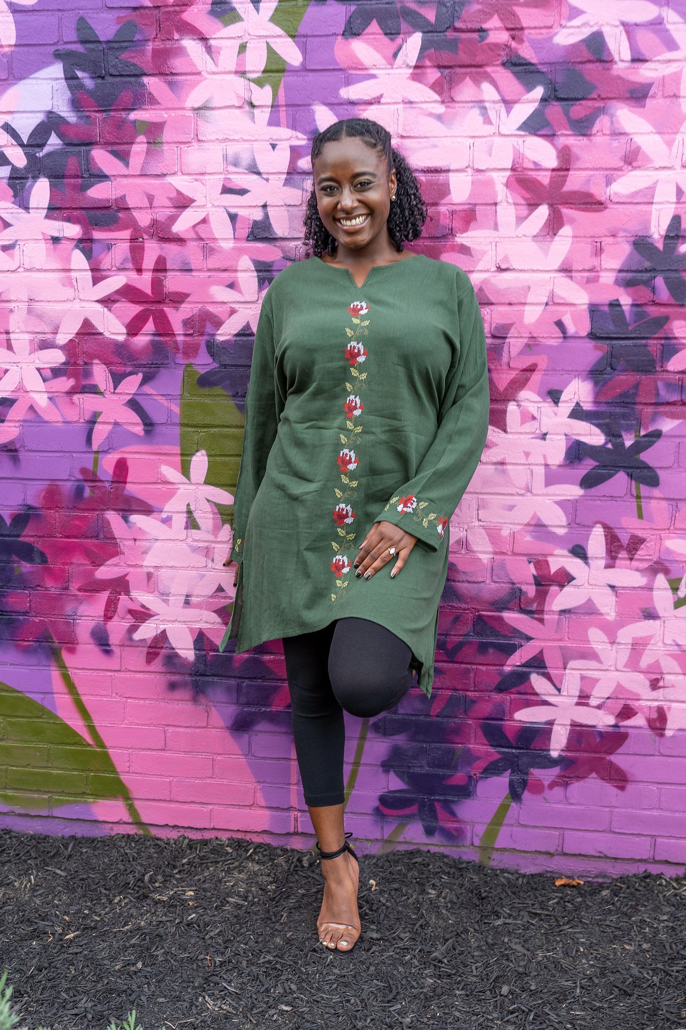 woman wearing a modest embroidered green long sleeve tunic