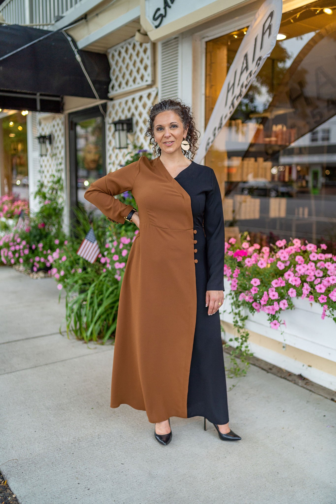 Woman in a black and beige sophisticated long sleeve long dress